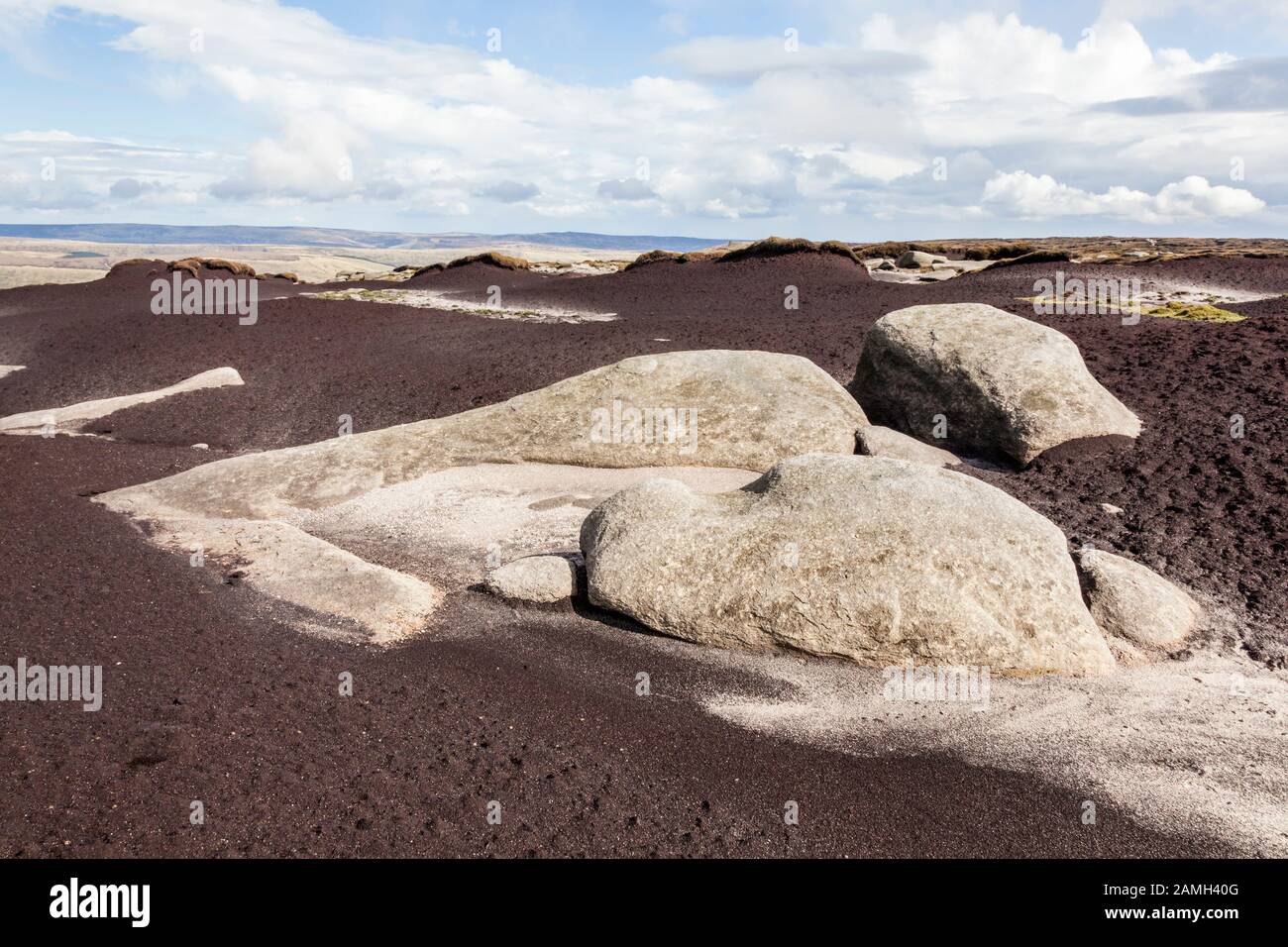 Moorish Rocks Gritstone rock showing through exposed peat on the moors due to ...