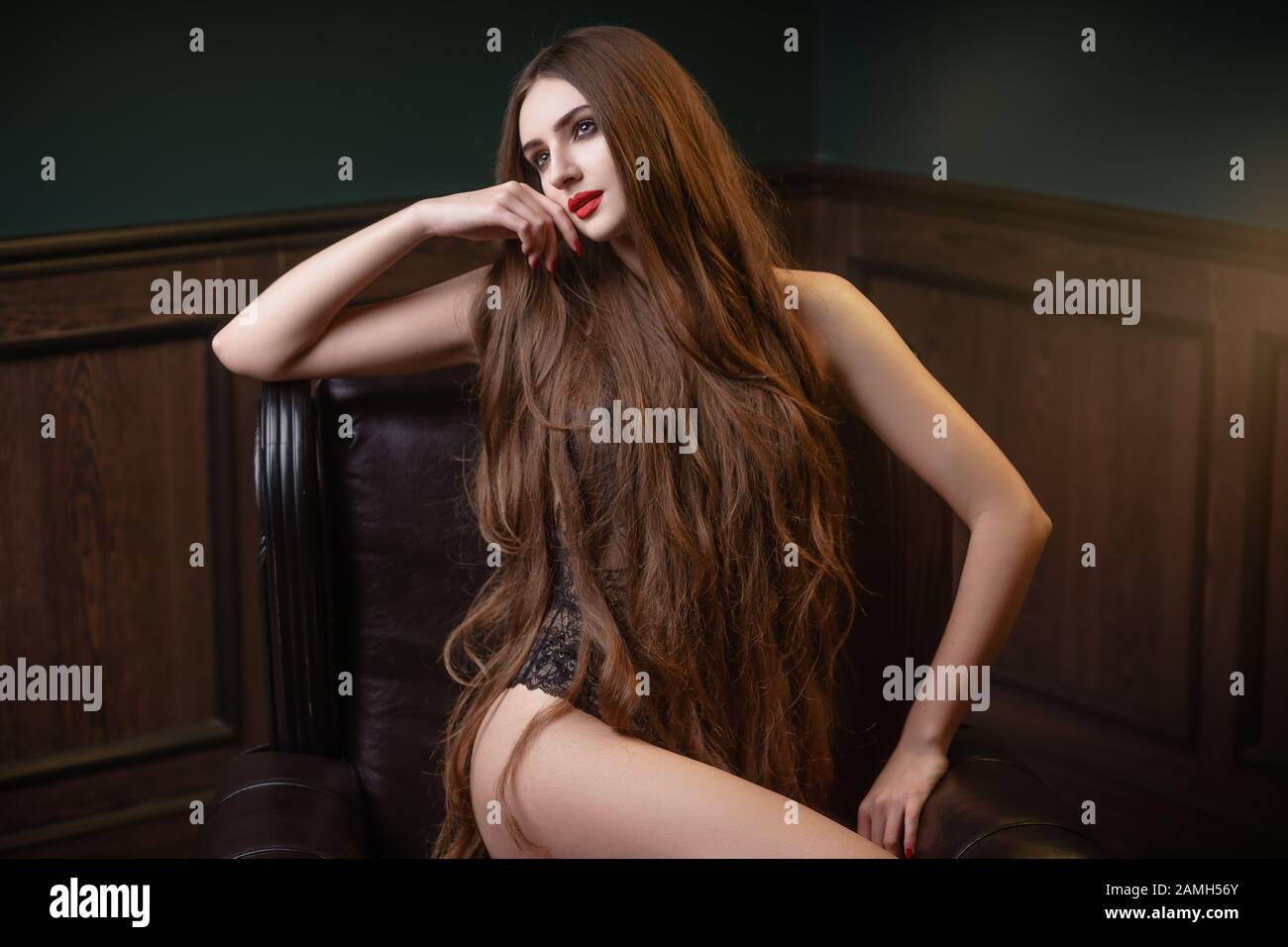 Concept: fashion, sensuality, tenderness, attraction. Beautiful woman with long hair sensual black lingerie studio photoshoot Stock Photo