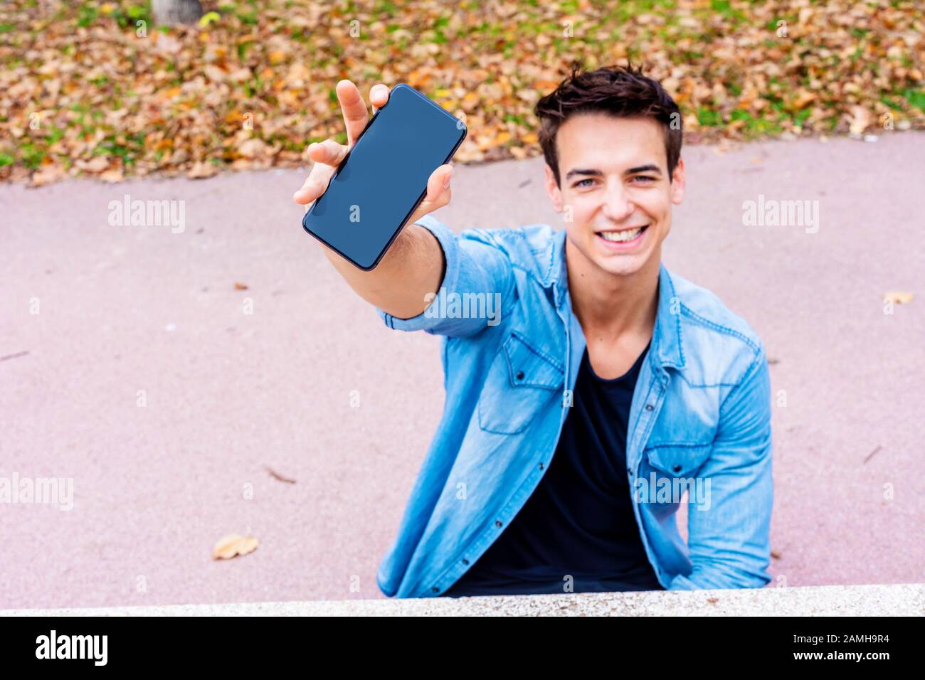 Young Man Showing an Empty Black Screen of his Mobile Phone at the ...