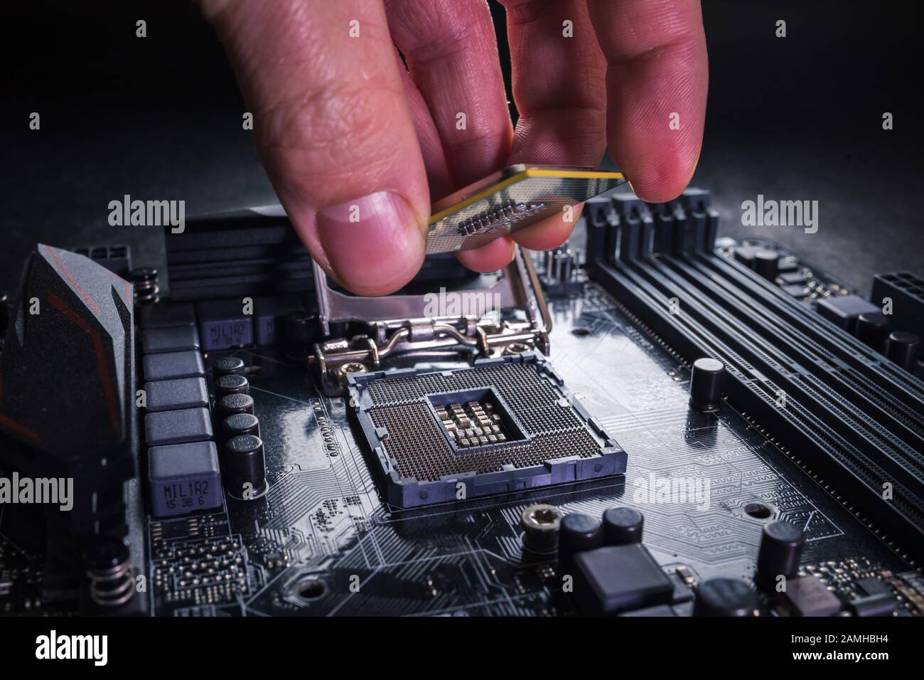 Installing modern central processor unit into motherboard. Copmputer CPU upgrade or repair concept. Stock Photo