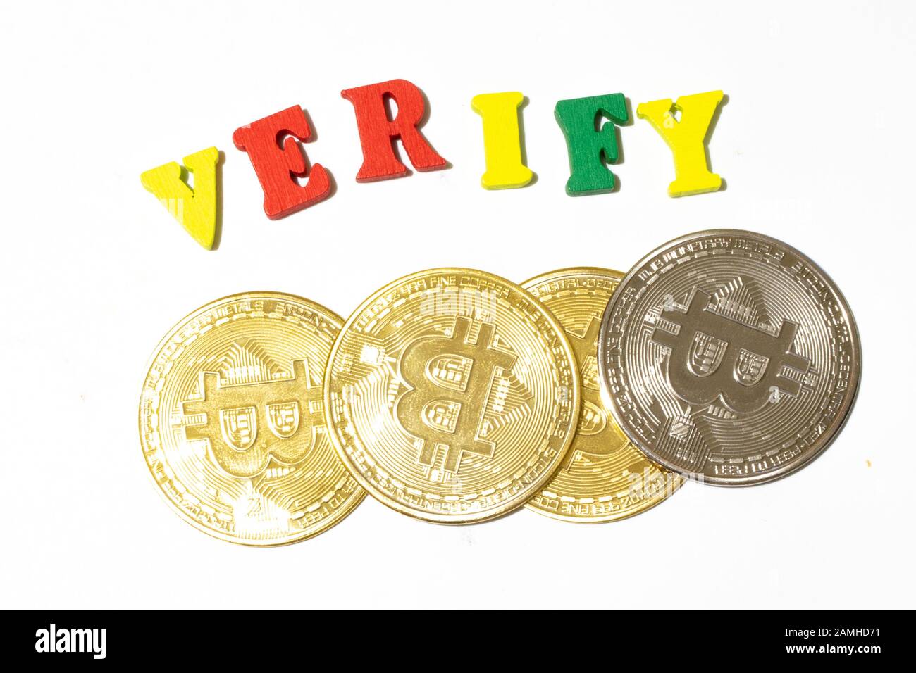 Verify word with bitcoin coins top view on white background. Verifying cryptocurrency transaction concept Stock Photo