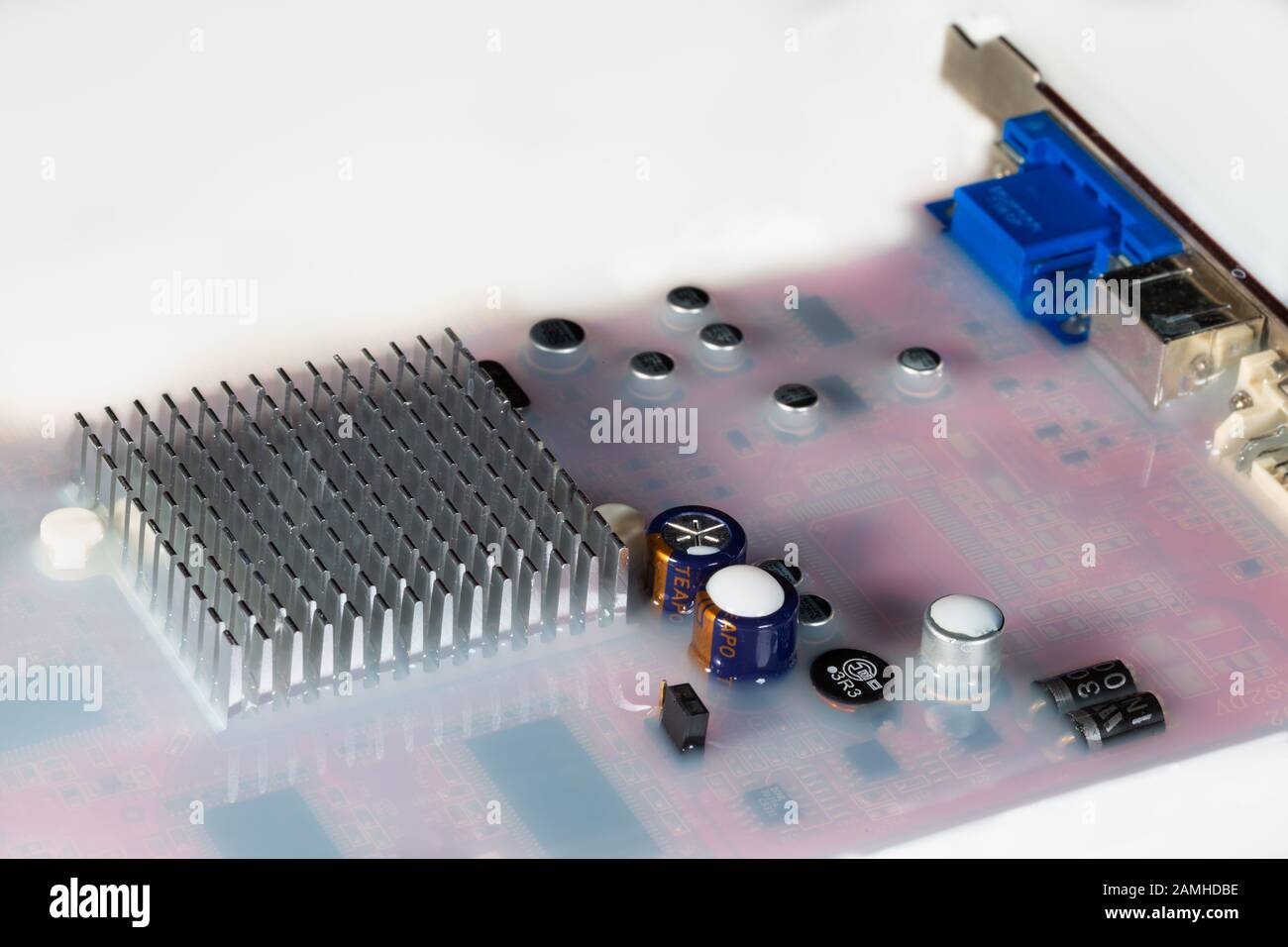 Video card computer flooded by white colored water Stock Photo