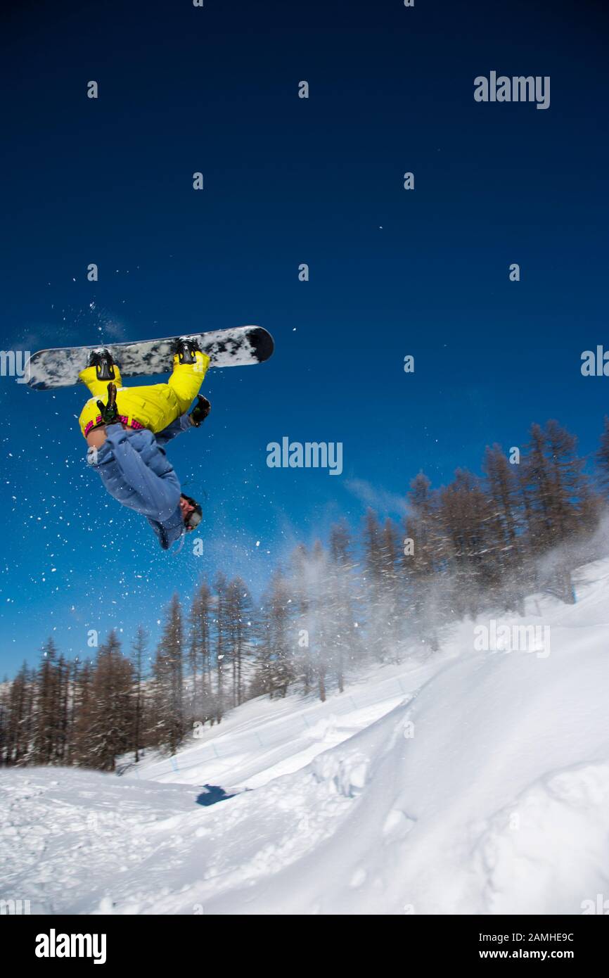 Snowboarder performing trick in snow park Stock Photo