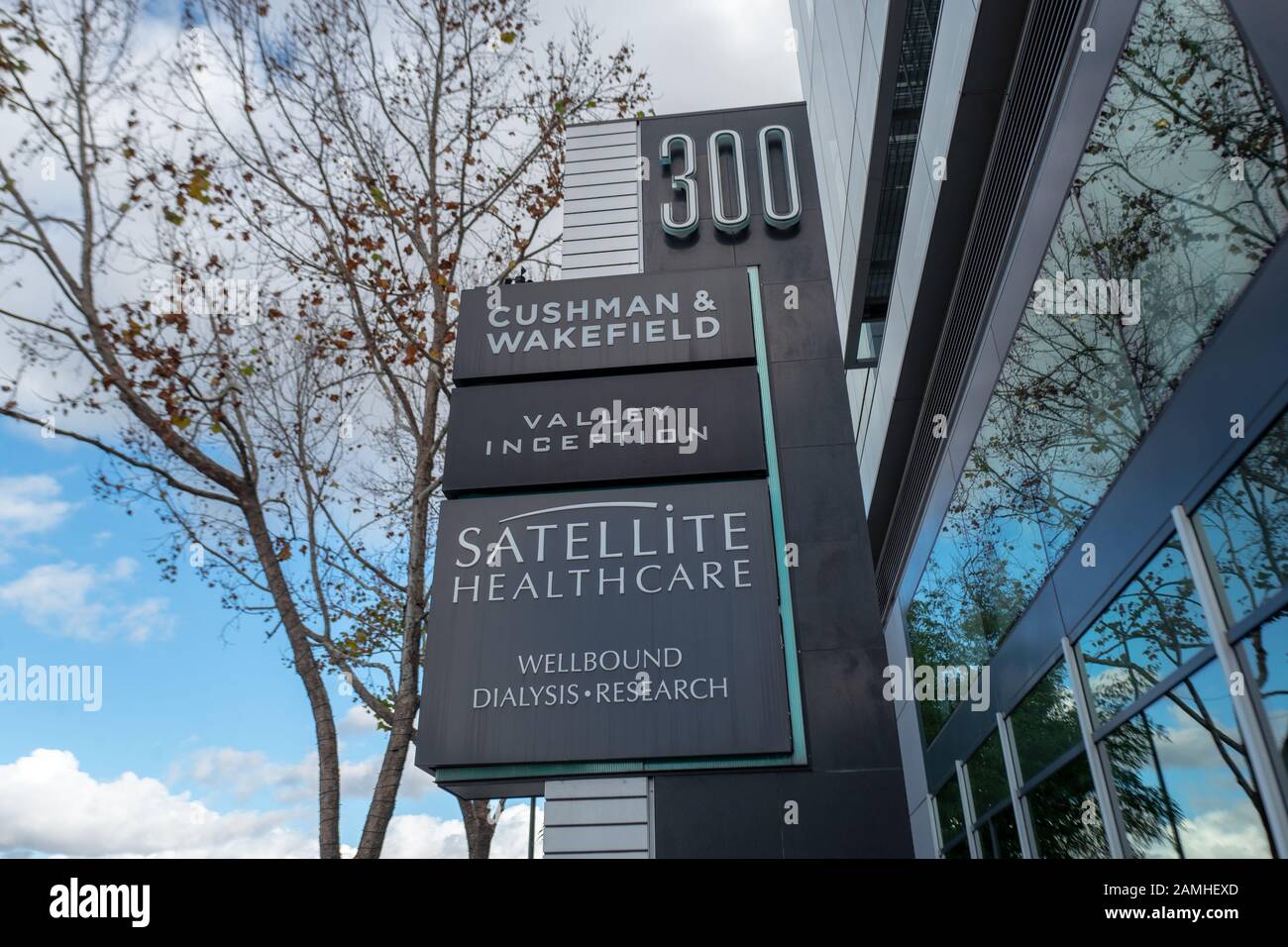 Sign with logos for businesses including Cushman and Wakefield, Valley Inception, Satellite Healthcare and Wellbound Dialysis Research on Santana Row in the Silicon Valley, San Jose, California, December 14, 2019. () Stock Photo