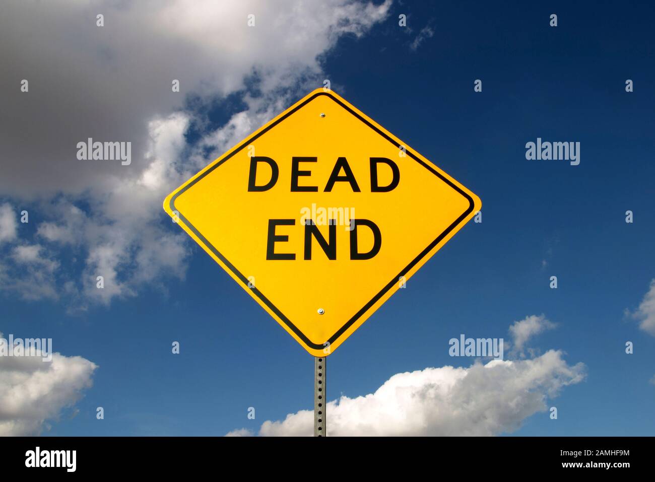 Dead end sign with blue sky and clouds behind Stock Photo