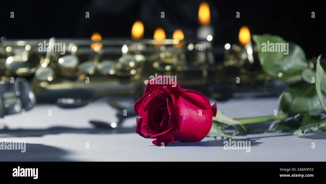 Red Roses And Saxophone red rose in black background.smoke and candles .romantic flower saint ...