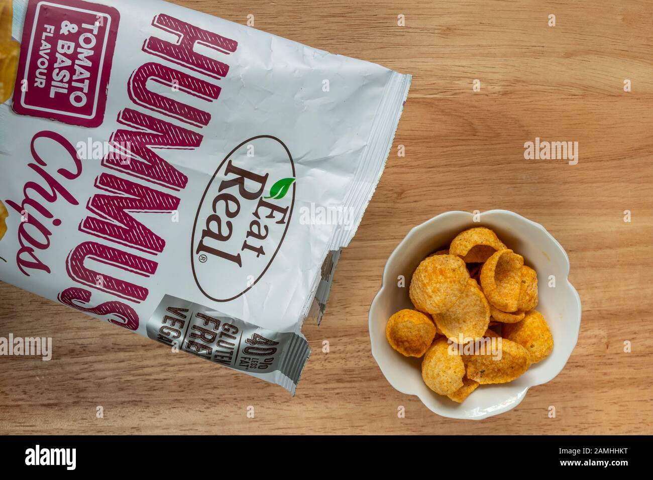 Packet of hummus chips tomato and basil flavour by Eat Real. Vegan and