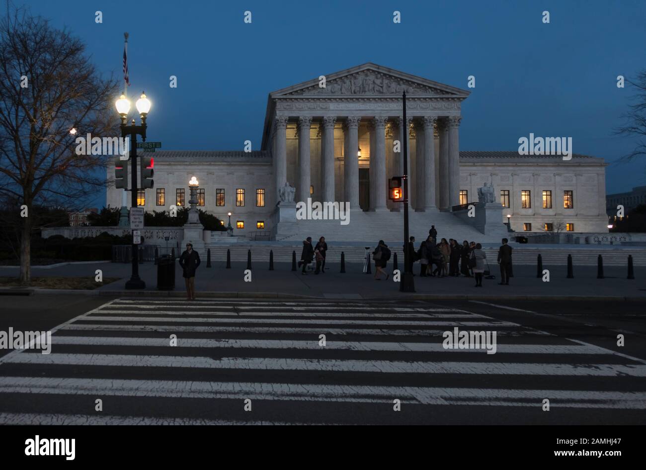 The US Supreme Court building at dusk, lights on in offices, working late. Supreme Court is across street from US Capitol, Washington, DC Stock Photo