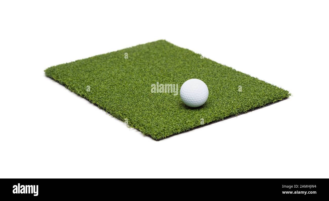 Golf Ball Resting on Section of Artificial Turf Grass On White Background. Stock Photo