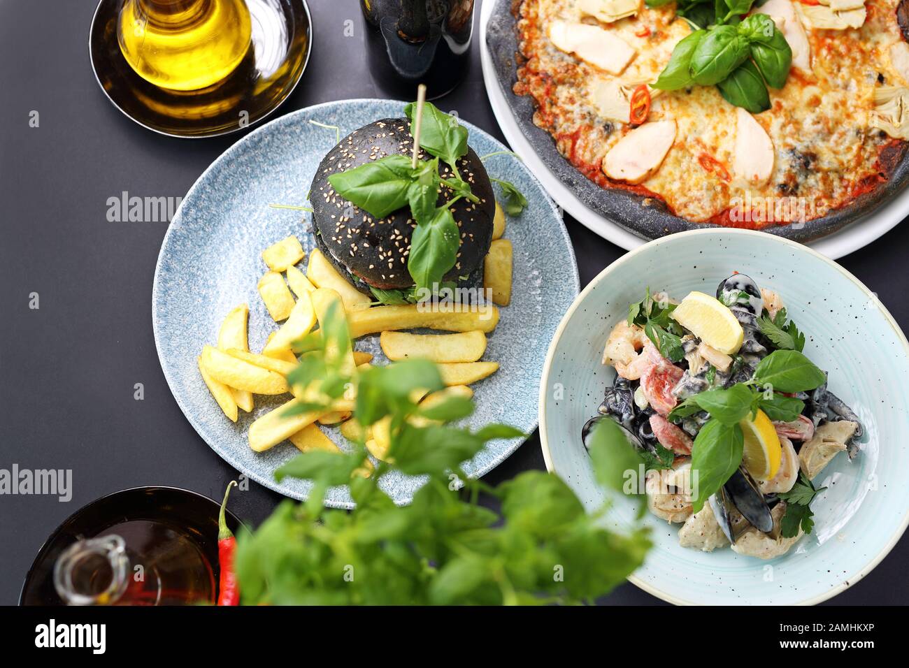 Black food. Burger, pizza, pasta, dishes with activated charcoal Stock Photo Alamy