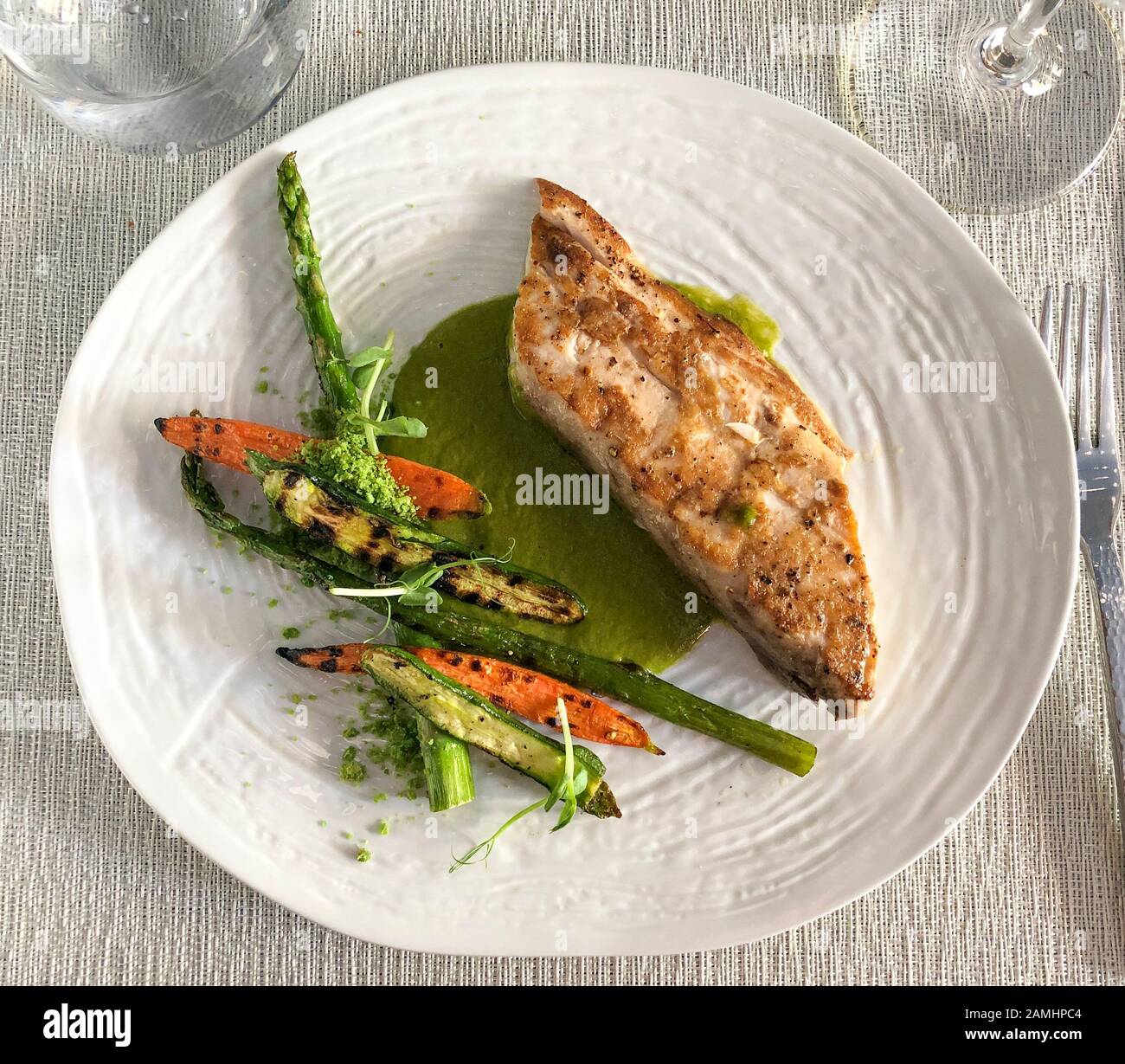 Fresh, locally purchased Mahi-mahi with herbal butter basil and parsley, accompanied by roasted vegetables at Hector's Kitchen in Punta de Mita, Rivie Stock Photo