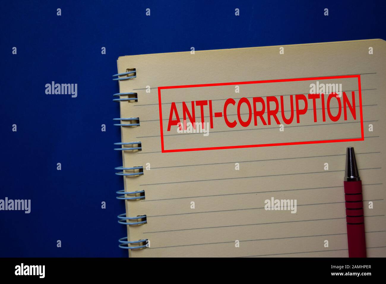 Anti-Corruption write on a book isolated on blue background. Stock Photo