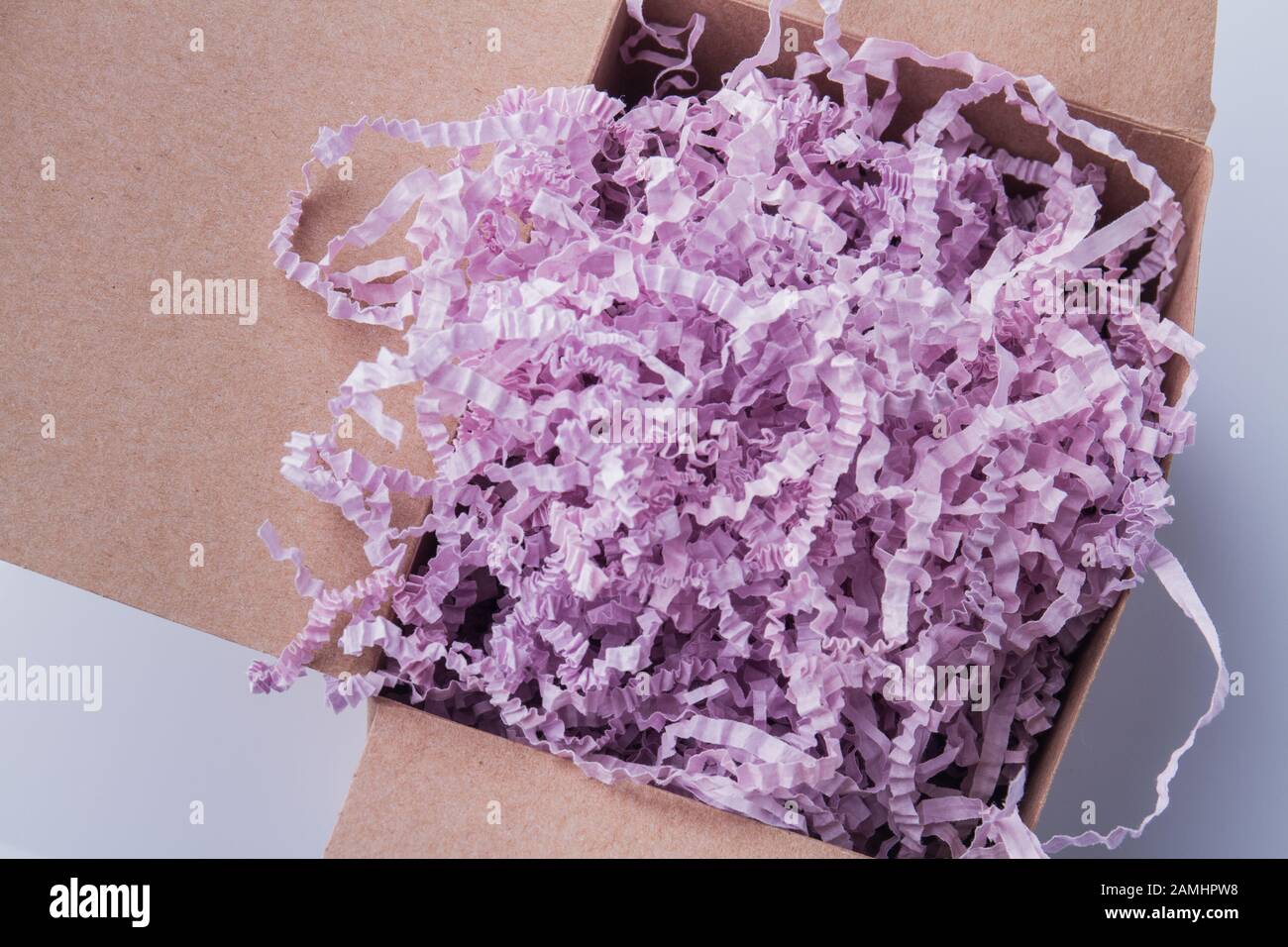 Pink shredded paper stuffing cardboard box Stock Photo Alamy
