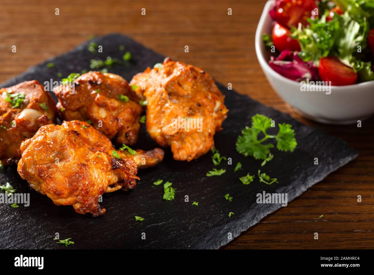 Roasted chicken drumsticks with fresh salad Stock Photo