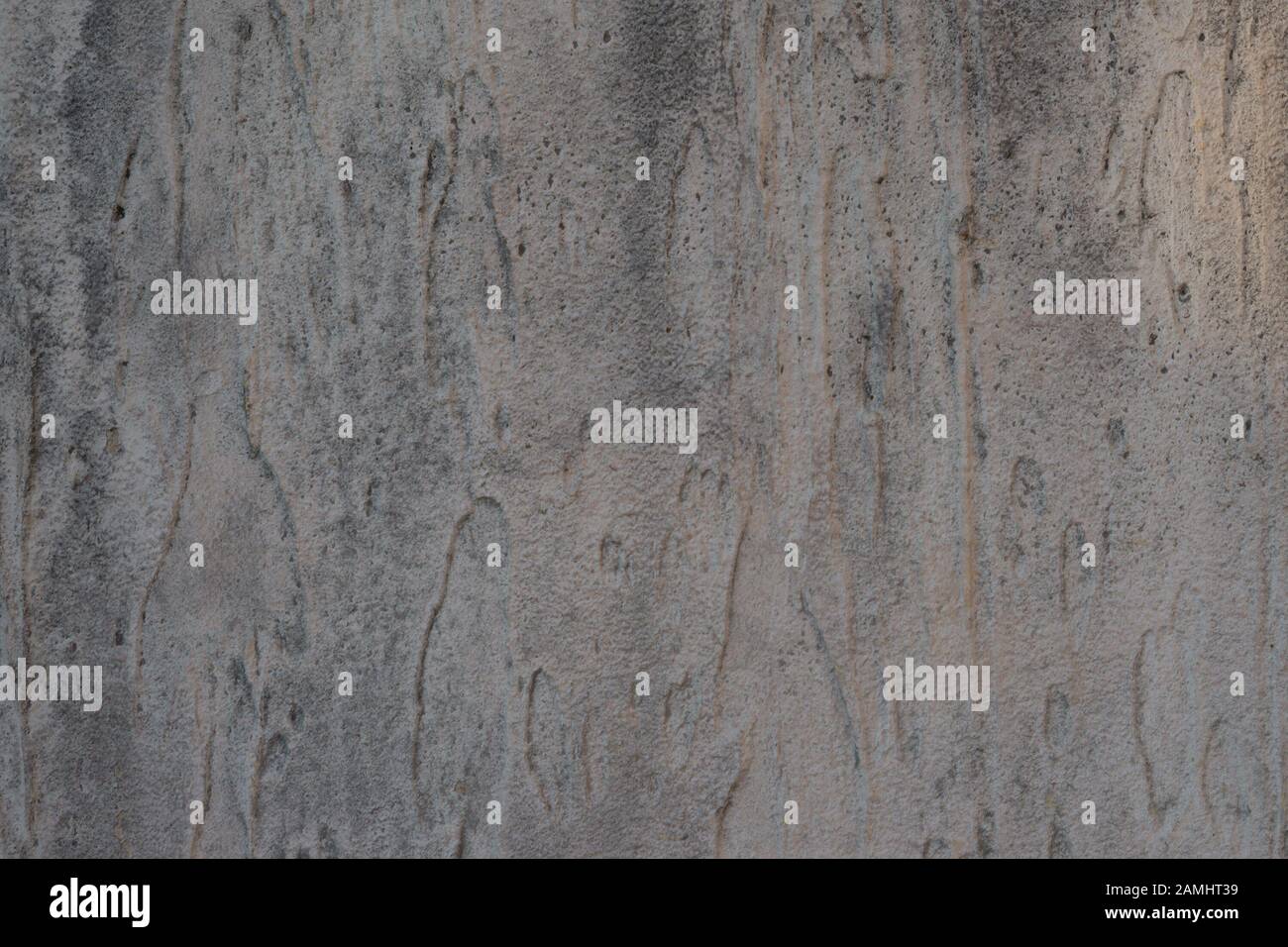 Structural gray aged stucco on the facade of the house. Creative vintage background Stock Photo