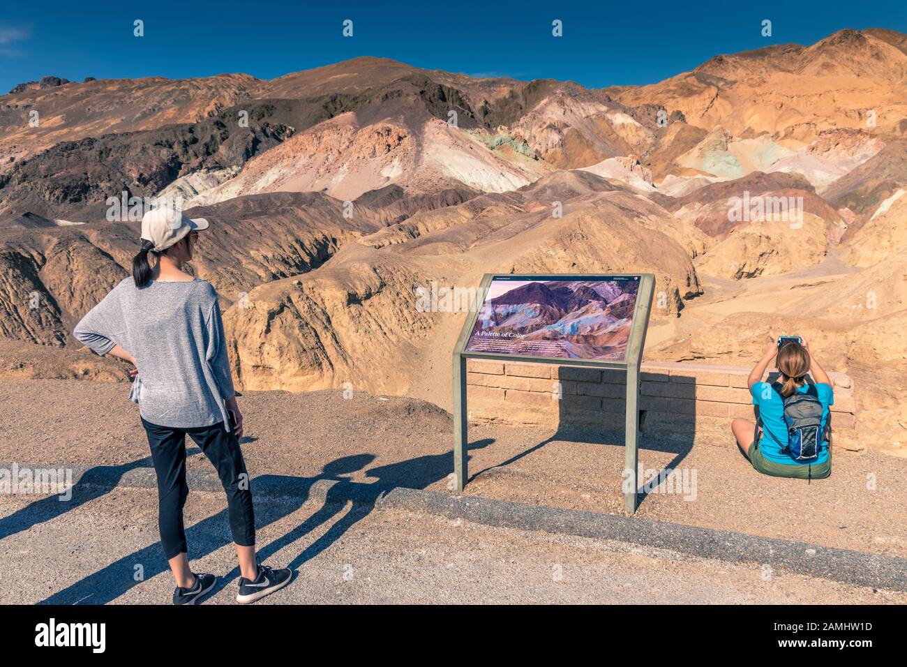 Tourists in the Artists drive Death Valley California USA looking at information about palette of colour Stock Photo