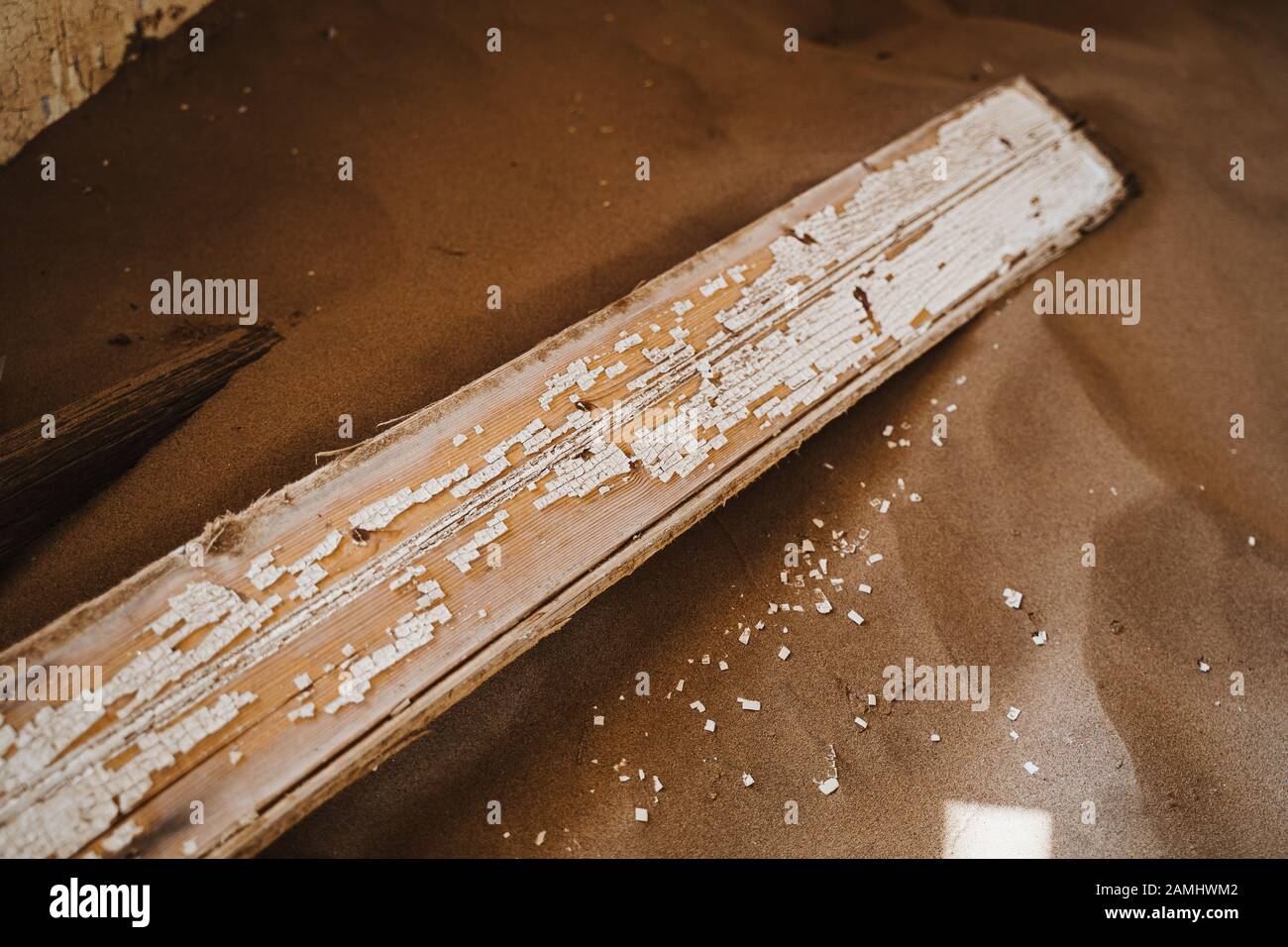 peeling off the white paint on a wooden slat Stock Photo