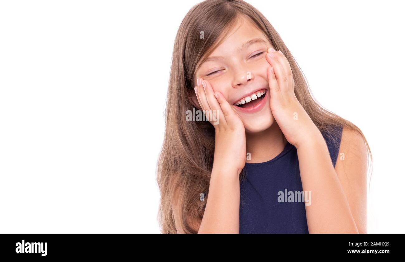Little girl laughs closing her eyes isolated on a white. Stock Photo