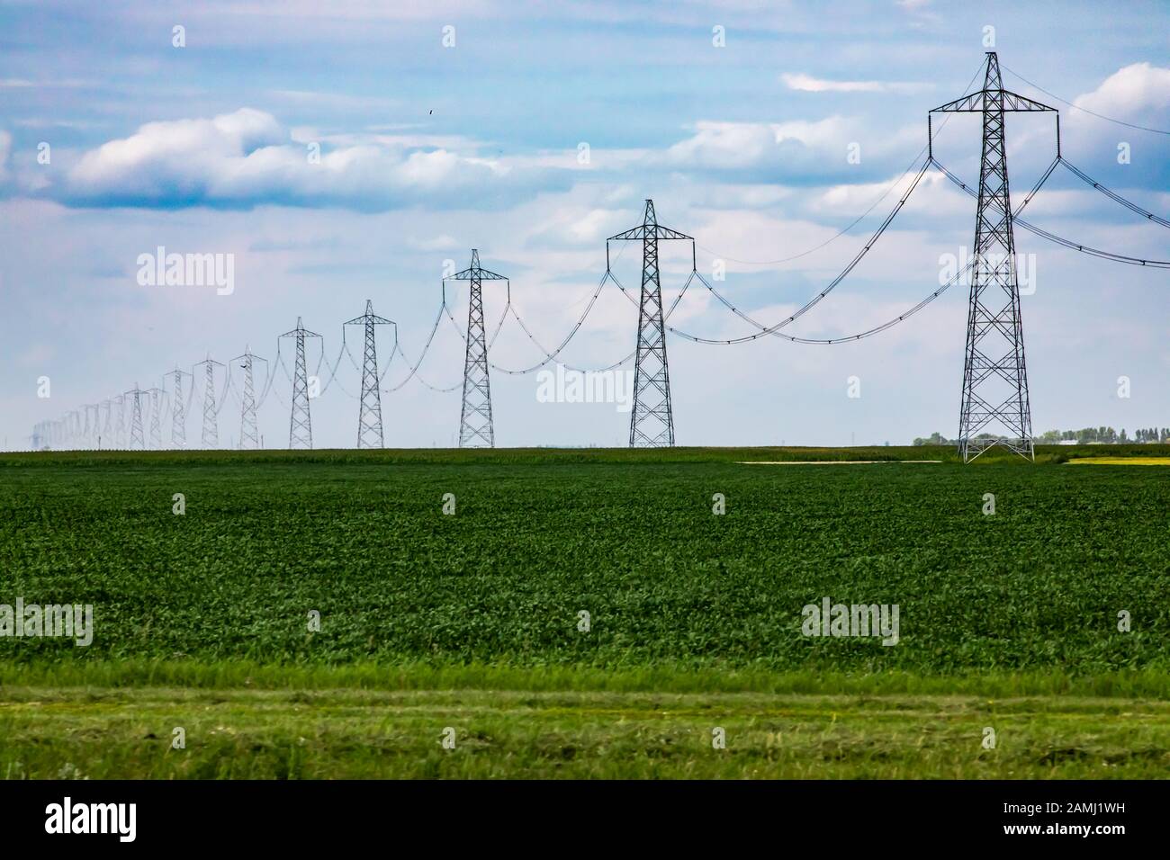A wide angle view of electricity pylons with miles of overhead power