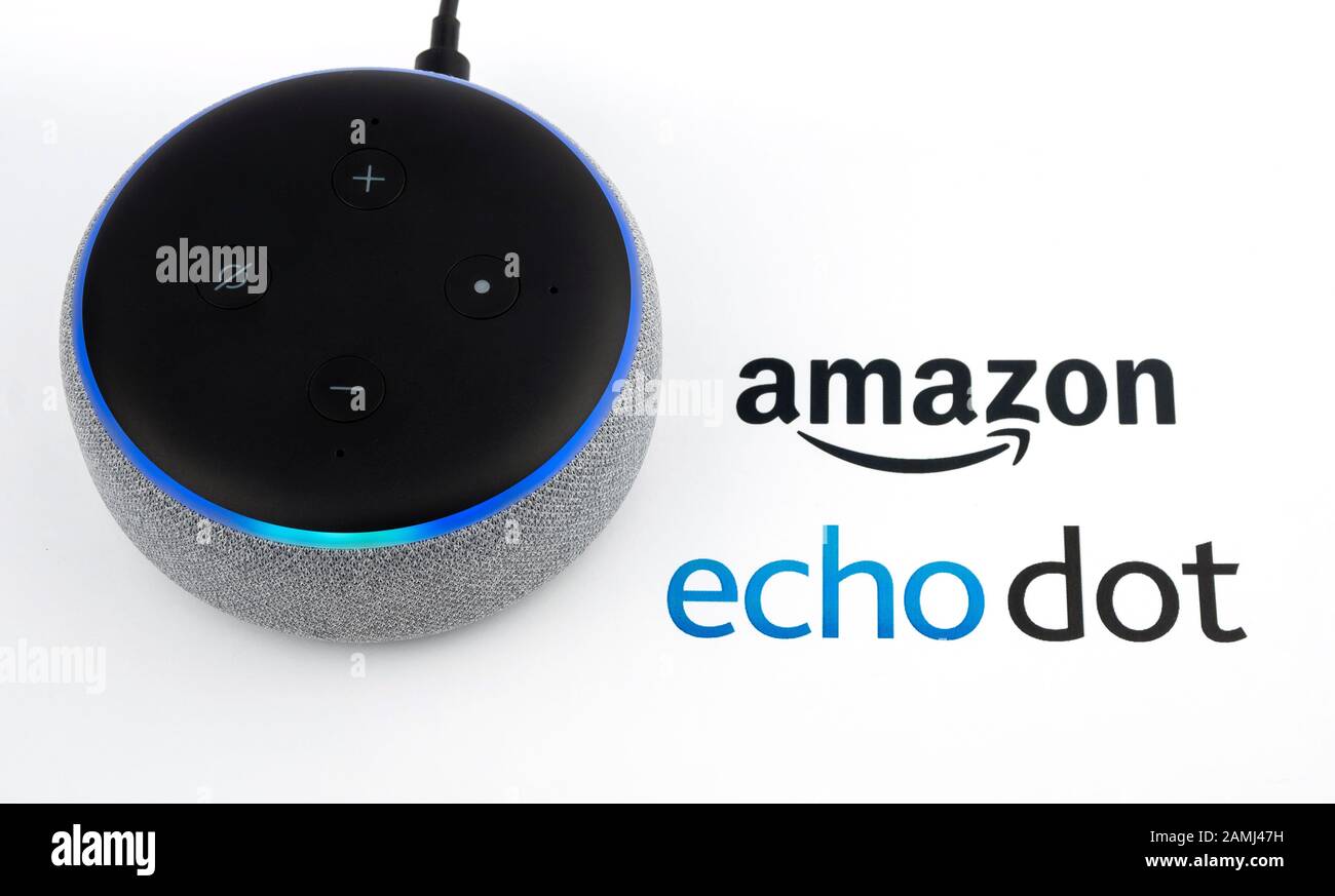 Amazon Echo Dot 3rd generation with blue lights on and device logo printed on paper. Smart speaker with Alexa assistant. Real photo, not a montage. Stock Photo