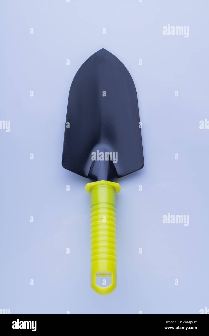 Steel garden trowel tool with yellow handle Stock Photo Alamy