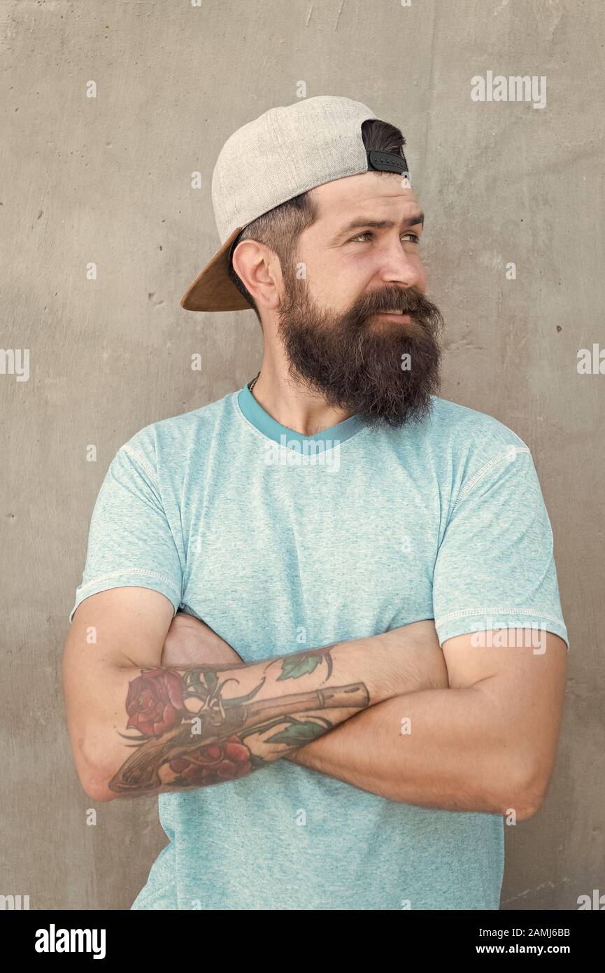 Cool Hipster With Beard Wear Stylish Cap Barber Salon And Facial Hair Care Hipster Lifestyle Brutal Handsome Mature Hipster Tattooed Man Bearded Man Trendy Style Beard And Mustache Grooming Stock Photo