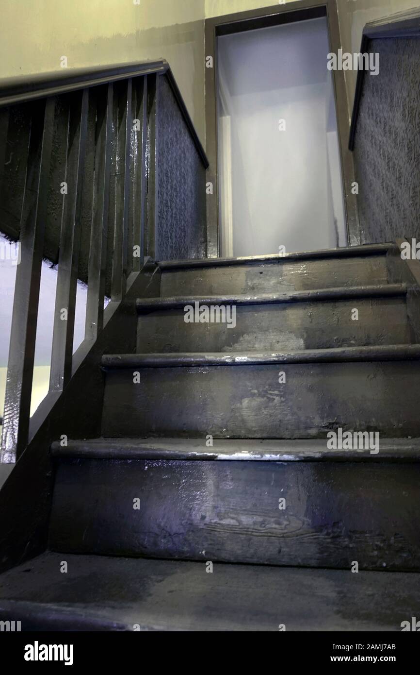 closed door at top of old wooden staircase Stock Photo