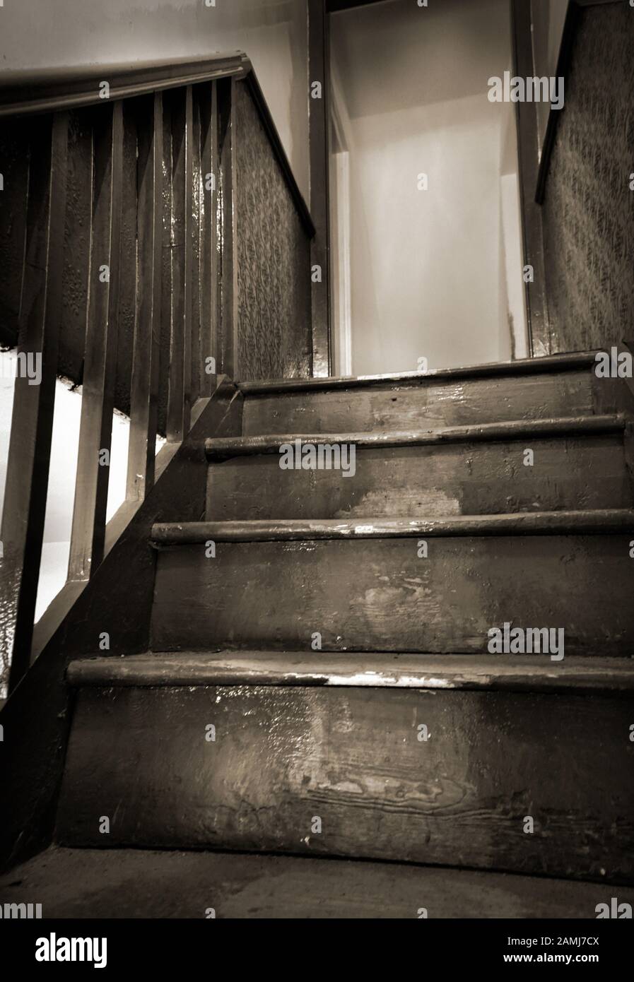 closed door at top of vintage  wooden staircase Stock Photo