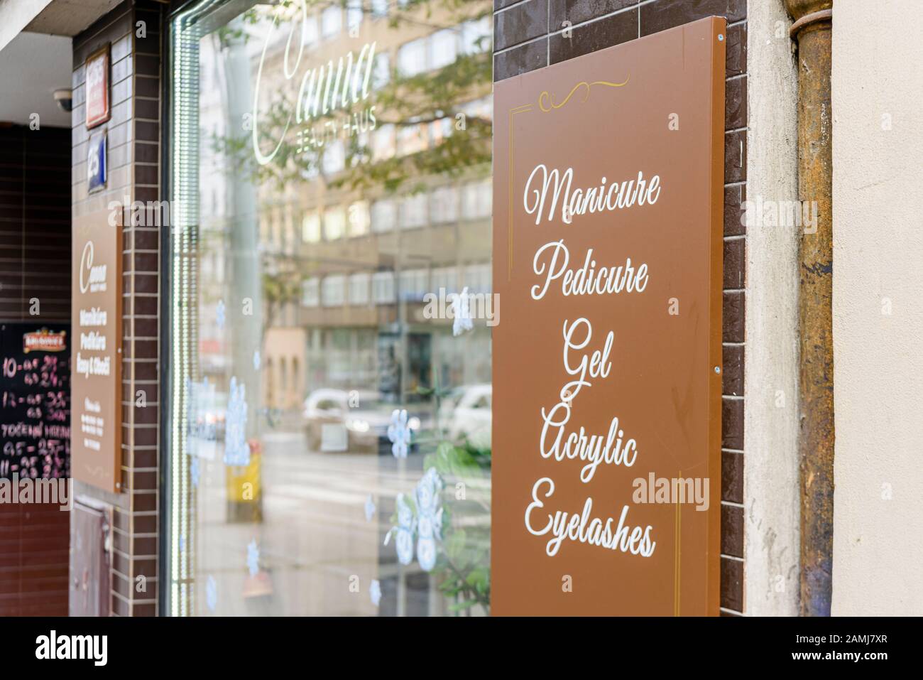 Sign outside a nail salon bar offering manicure, pedicure, gel nails, acrylic nails and eyelashes. Stock Photo