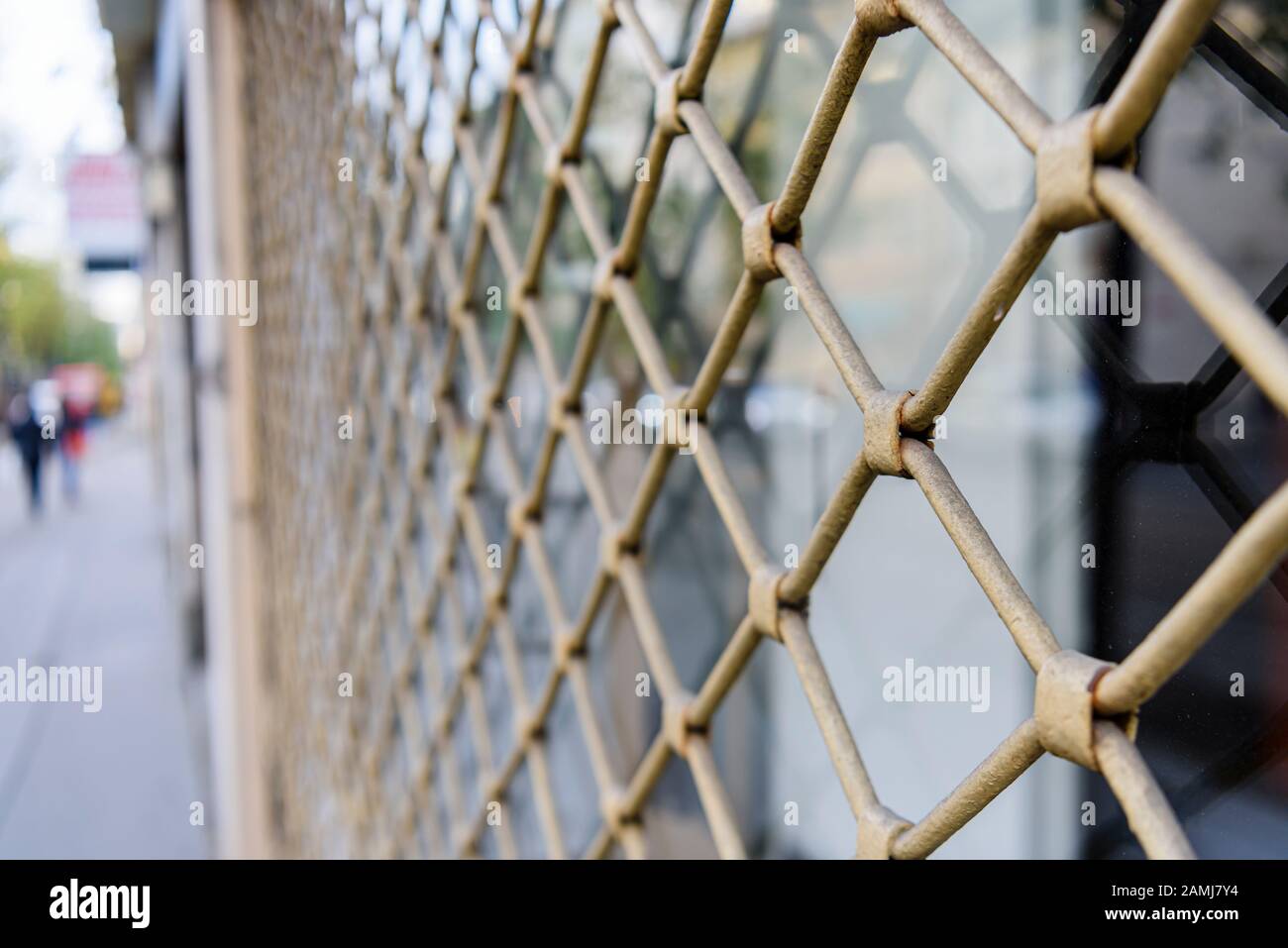 Steel security grill on a shop window. Stock Photo