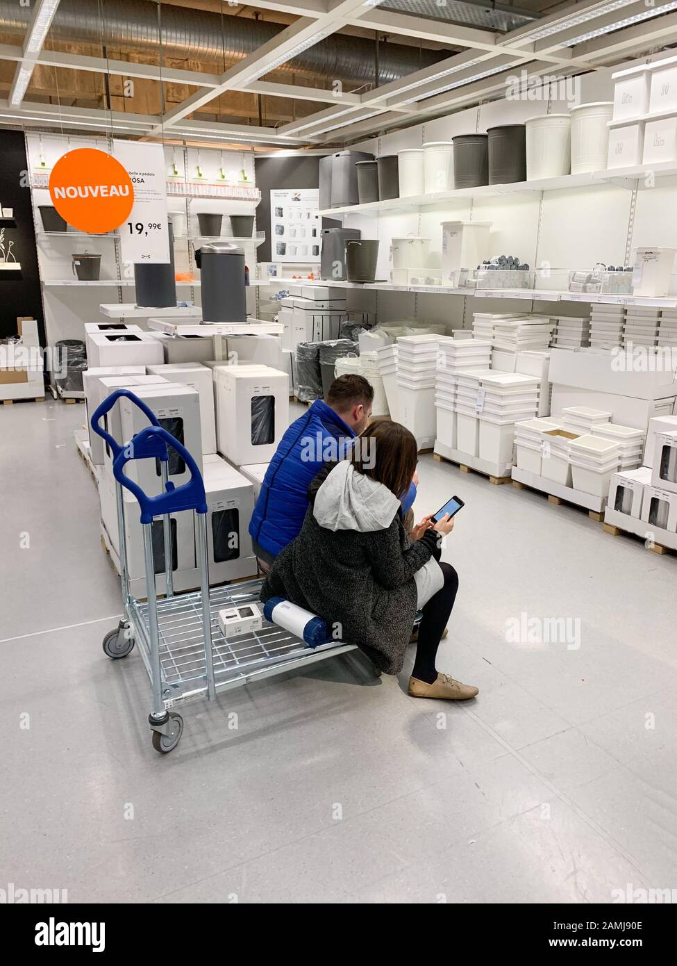 Paris, France - Dec 1, 2018: Couple deciding inside IKEA store what to buy  sitting on a shopping car with smartphone phone as a calculator Stock Photo  - Alamy