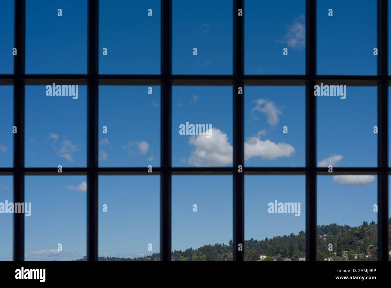 View of blue summer sky through a grid. Stock Photo