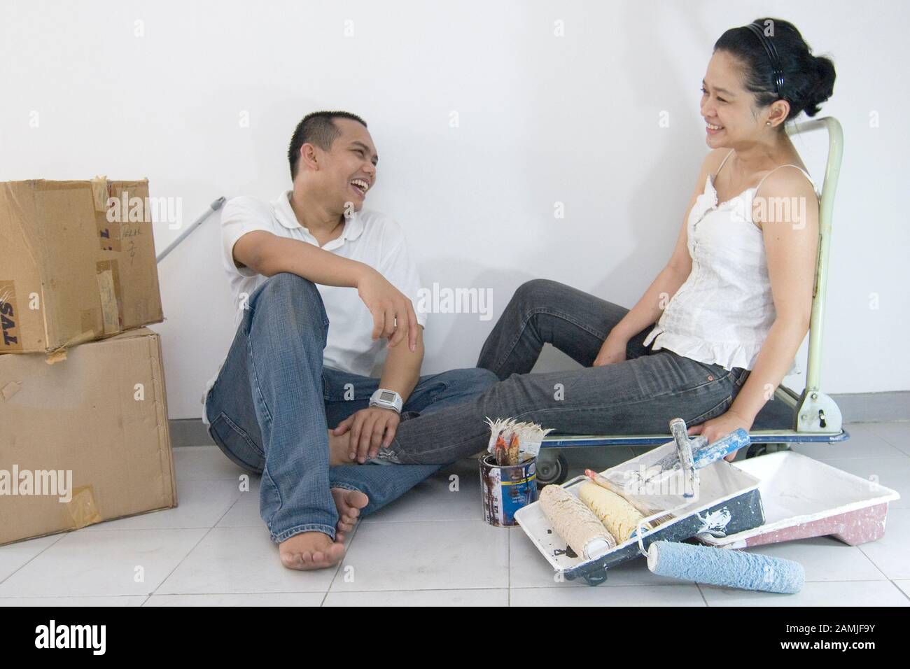 A couple talk about renovation in their house. Stock Photo