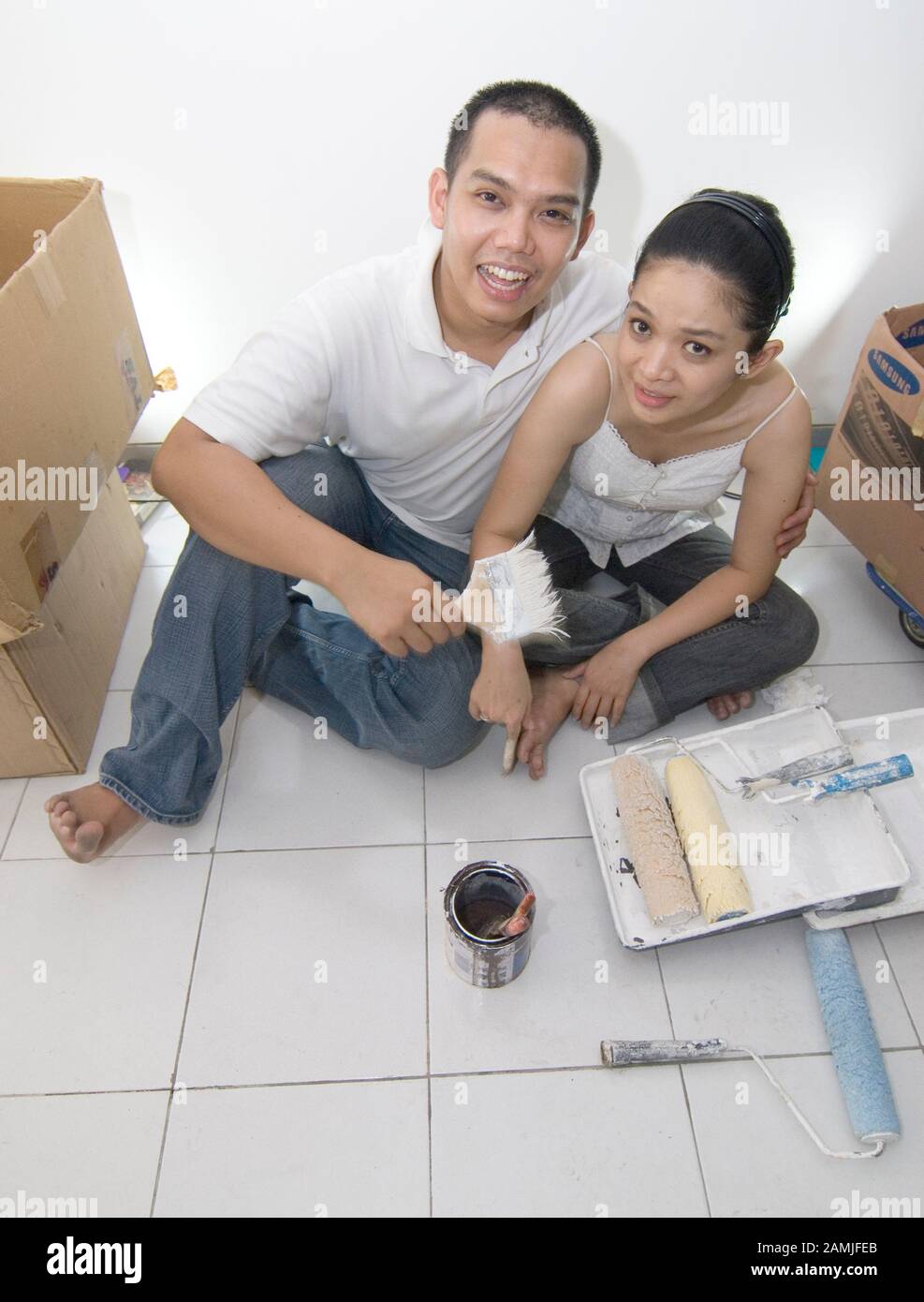 A couple sit in their house after renovation. Stock Photo