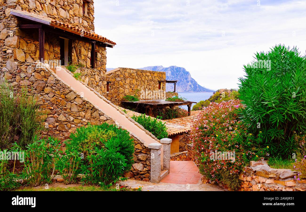 Cottage at Capo Coda Cavallo at Mediterranean sea reflex Stock Photo Cottage at Capo Coda Cavallo at Mediterranean sea reflex Stock Photo