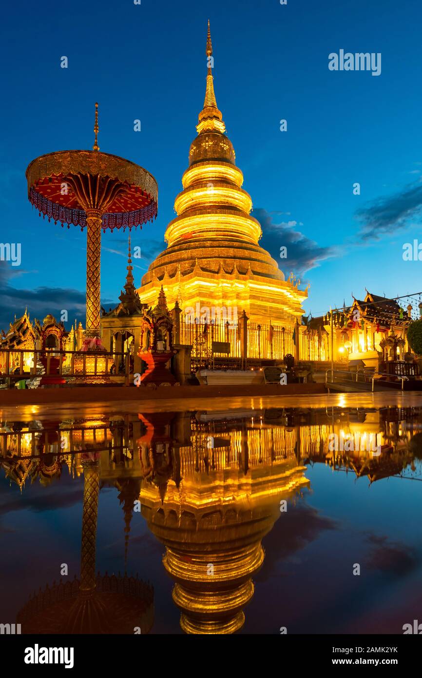 Wat Phra That Hariphunchai with water reflection in Lamphun, Thailand Stock Photo