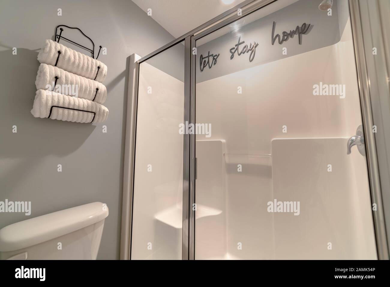 Neatly rolled white towels in a wall holder Stock Photo