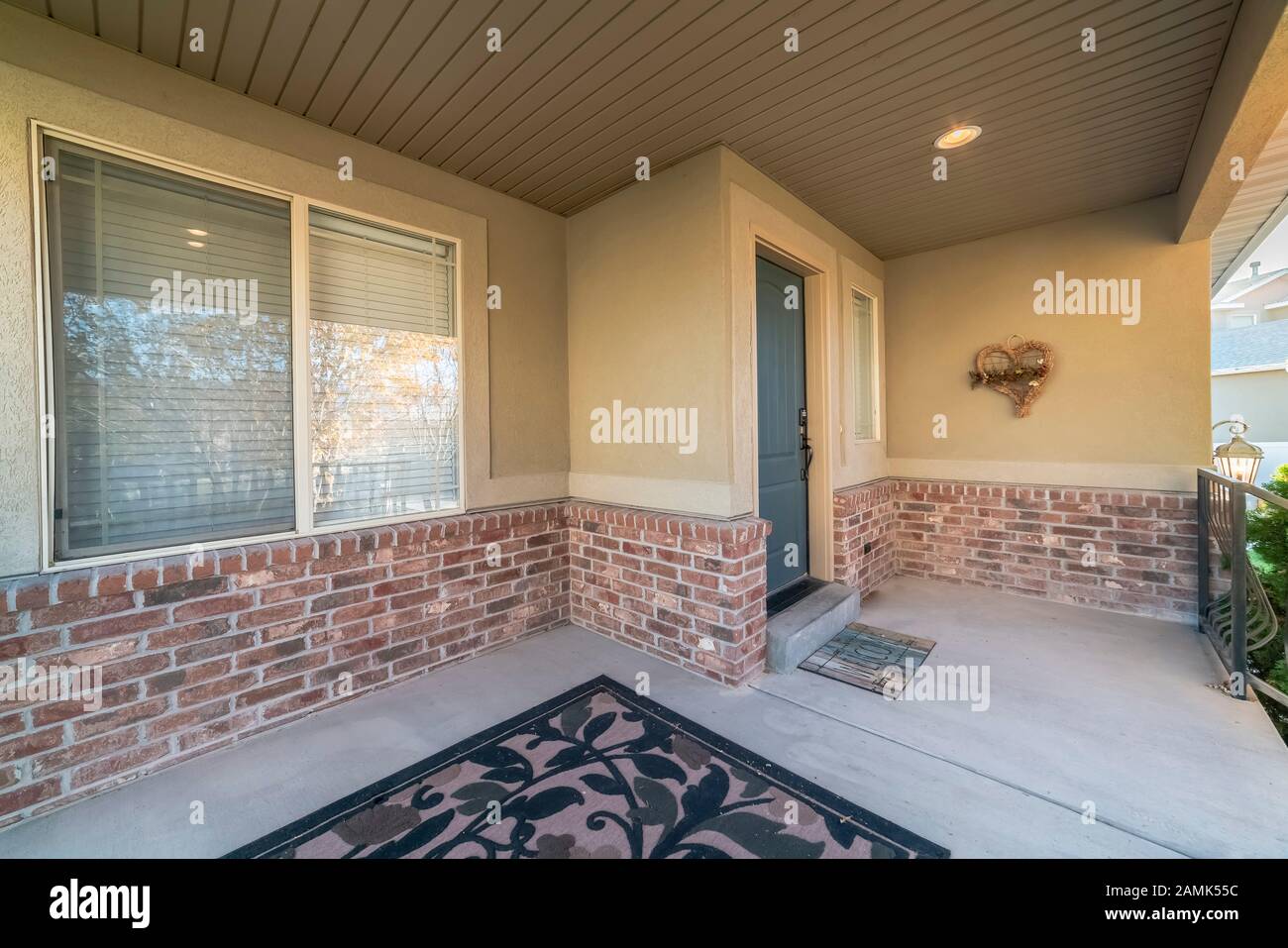 Covered front patio on a modern brick house Stock Photo - Alamy