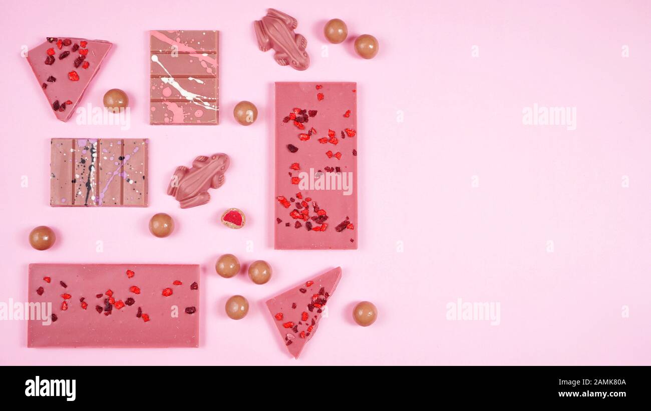Ruby chocolate selection, made from botanical cocoa bean varieties that have the right attributes to be processed into ruby chocolate, flat lay on pin Stock Photo