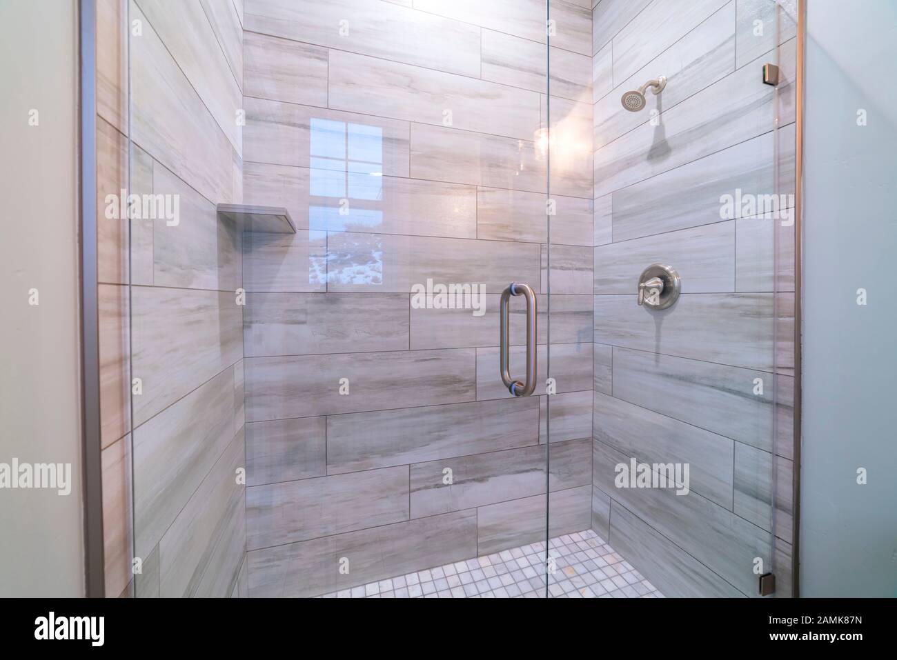 Large modern tiled shower cubicle bright interior Stock Photo