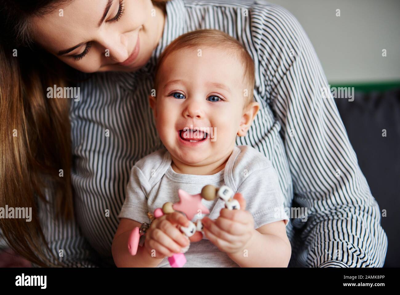 Affectionate mother embracing her little daughter Stock Photo