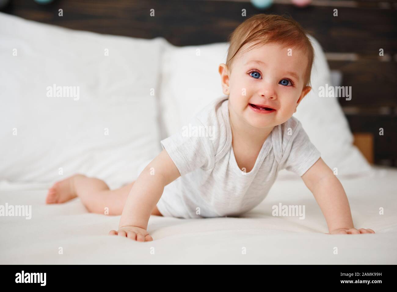 Portrait of baby crawling on the bed Stock Photo Alamy