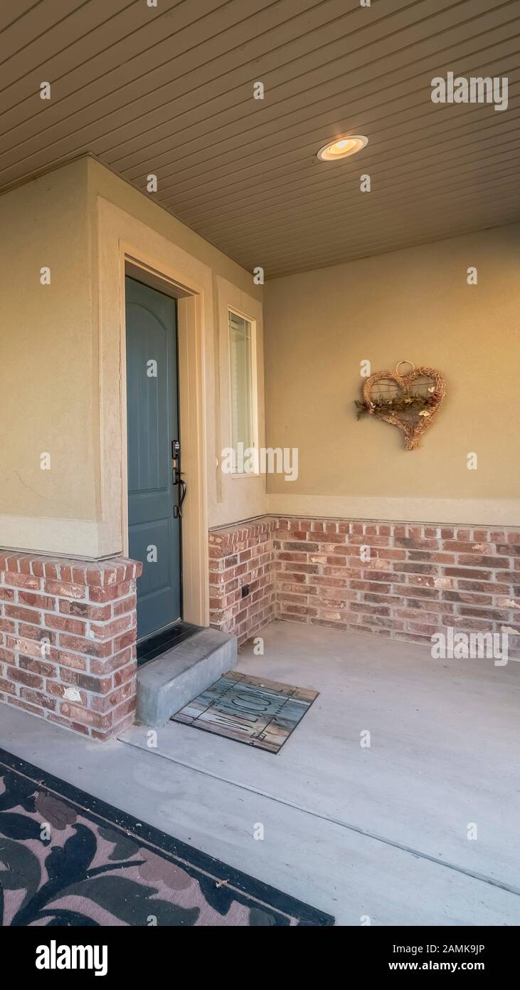 Vertical Covered front patio on a modern brick house Stock Photo - Alamy