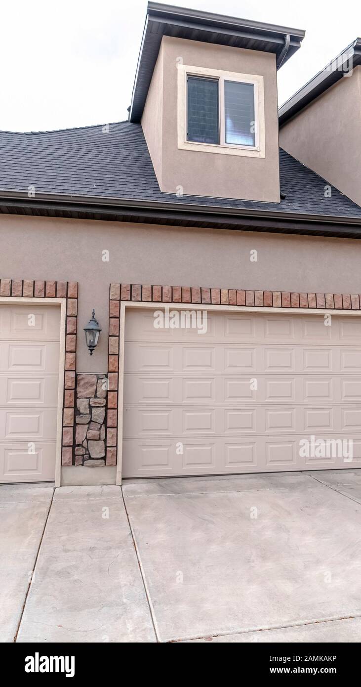 Vertical frame Urban house with a single and double garages Stock Photo ...