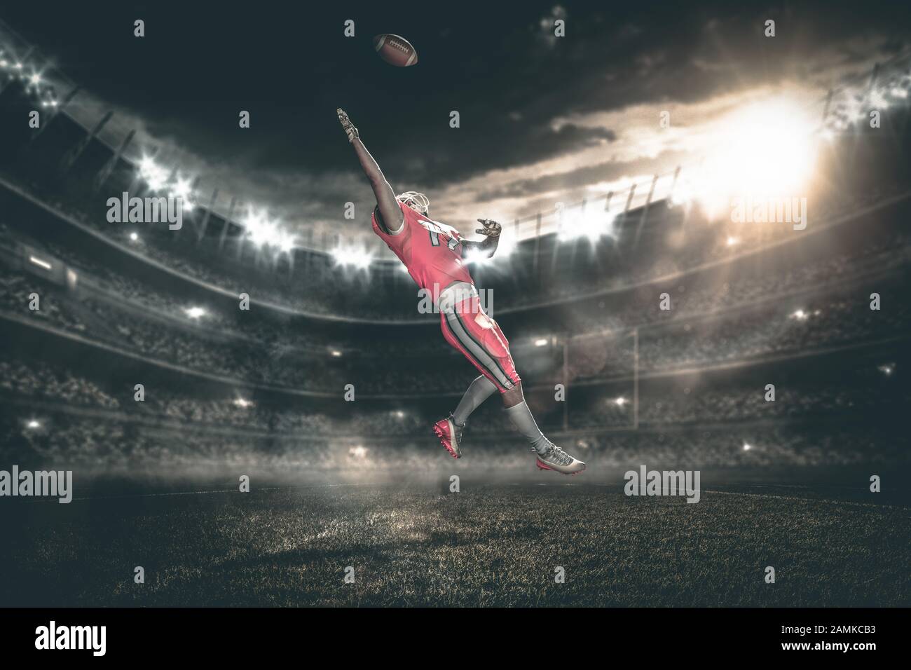 american football player catches ball in midair Stock Photo Alamy