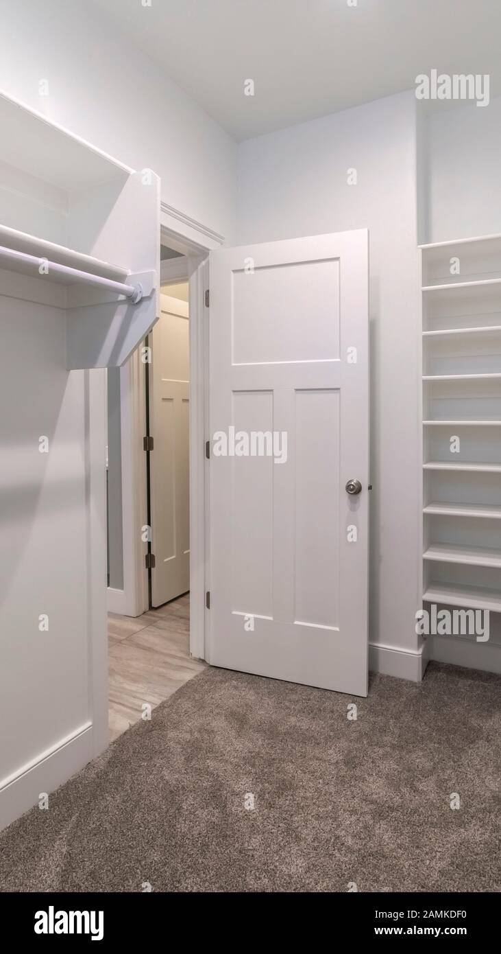 Vertical Interior of an empty walk-in closet or wardrobe Stock Photo ...