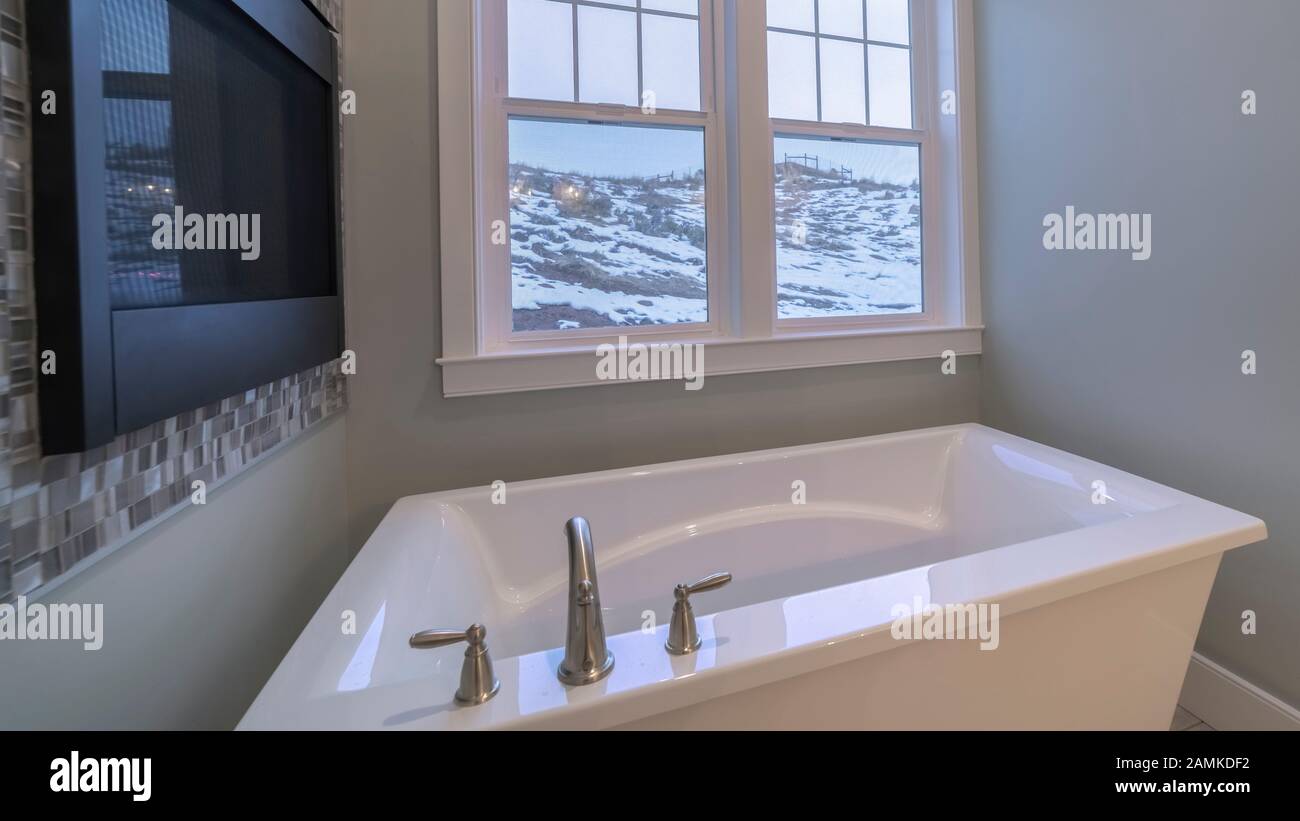 Panorama Small compact modern bathroom with deep tub Stock Photo - Alamy