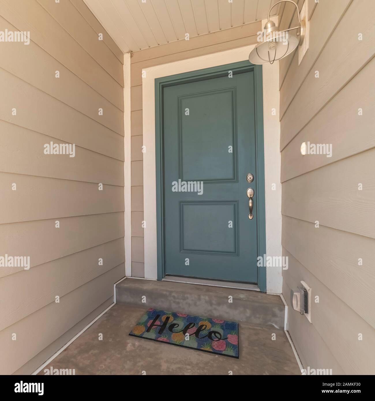 Square Frame Blue Wooden Front Door With Hello Welcome Mat Stock