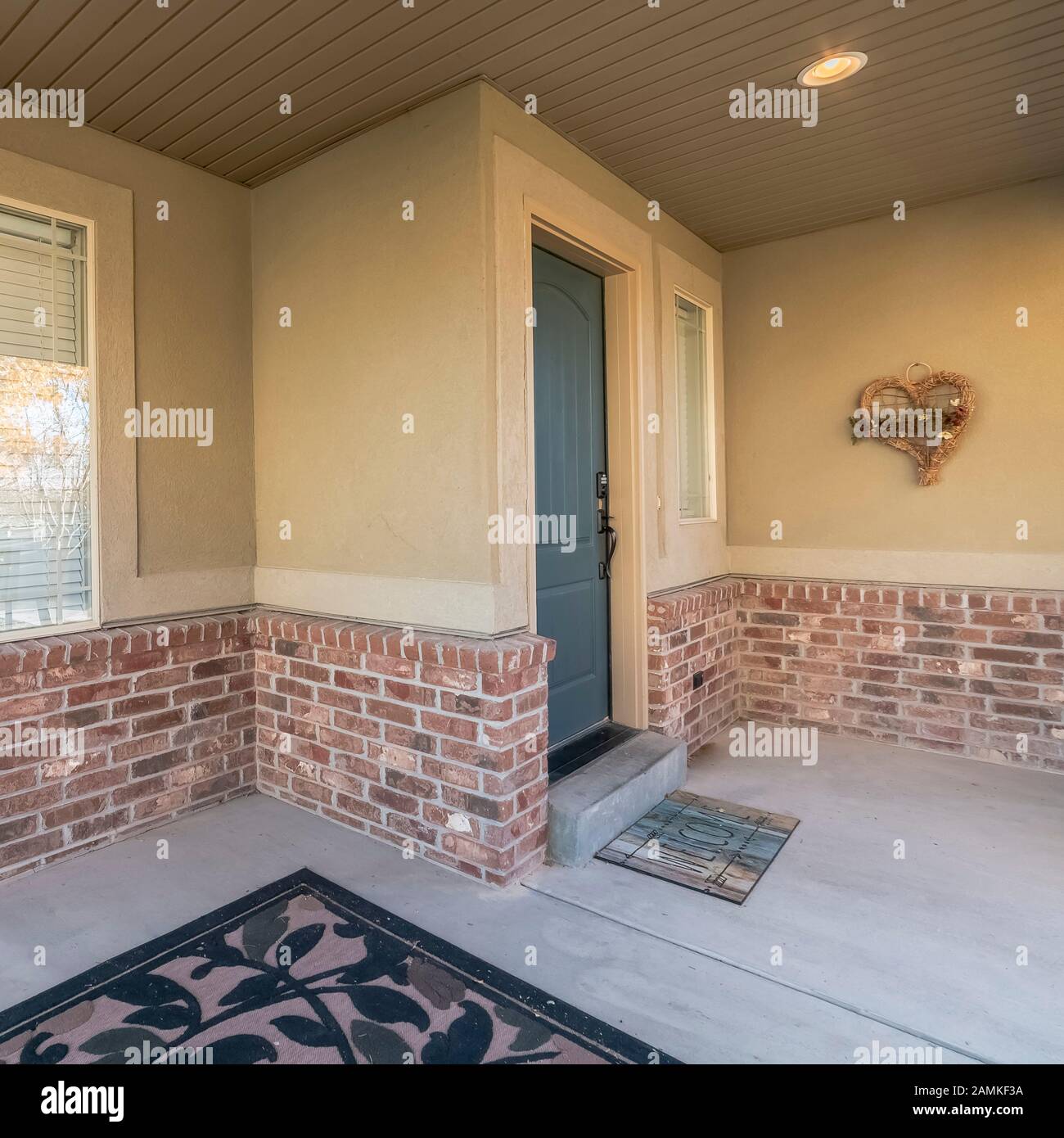 Square Covered front patio on a modern brick house Stock Photo - Alamy