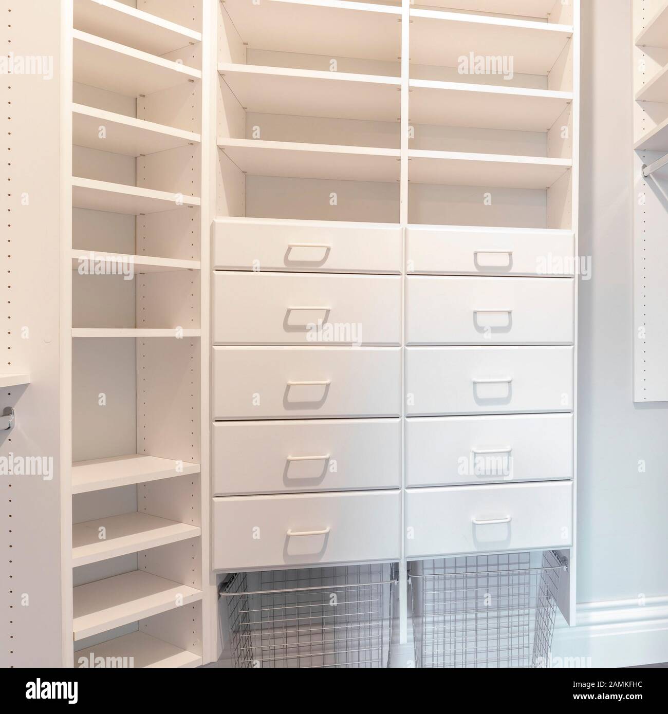 Square frame Fully fitted empty white walk-in wardrobe bright interior Stock Photo